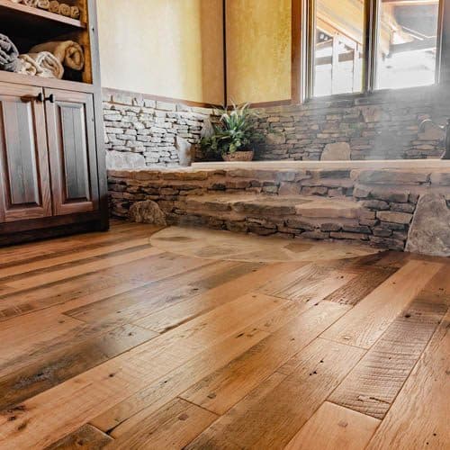 Solid wide-plank hardwood flooring running through an open living space